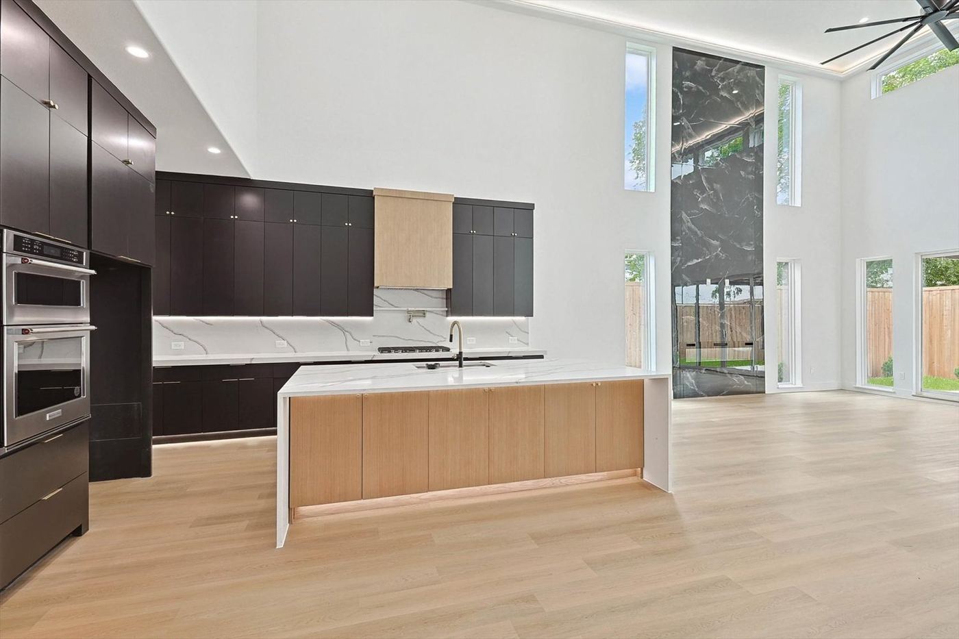 A modern Luxe Homes Dallas kitchen with dark cabinetry